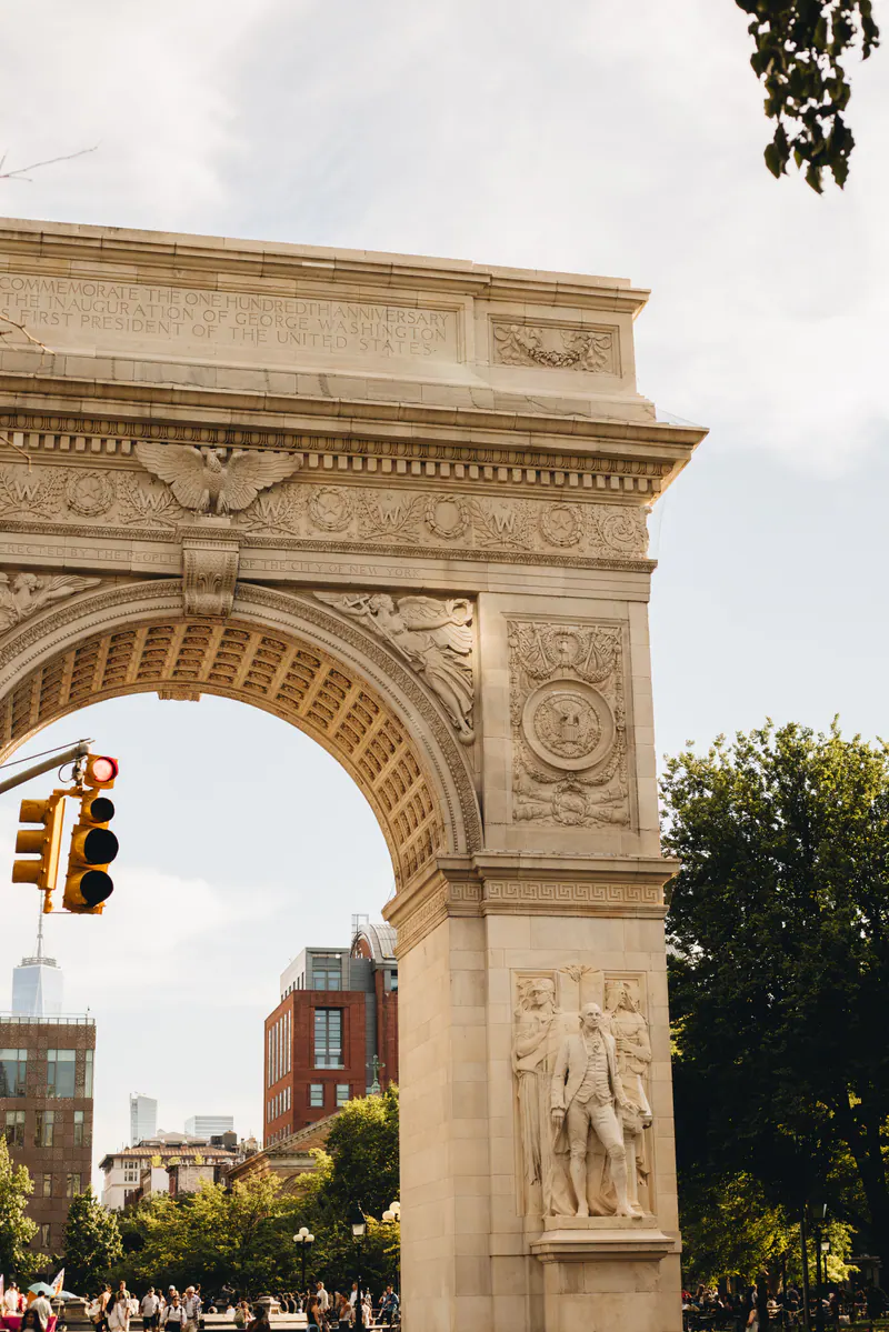 The Washington Square Arch with a traffic light in front of it