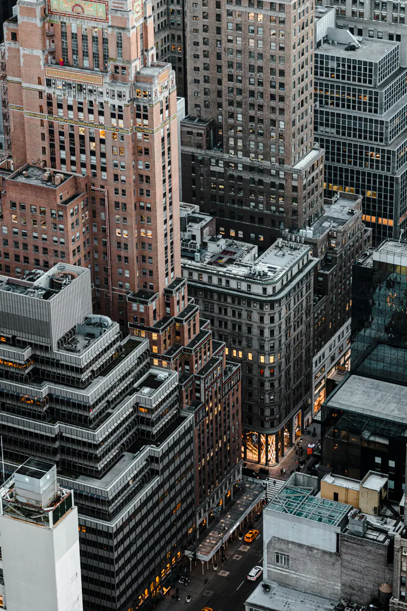 Stepped brick towers and rooftops at dusk, seen from above