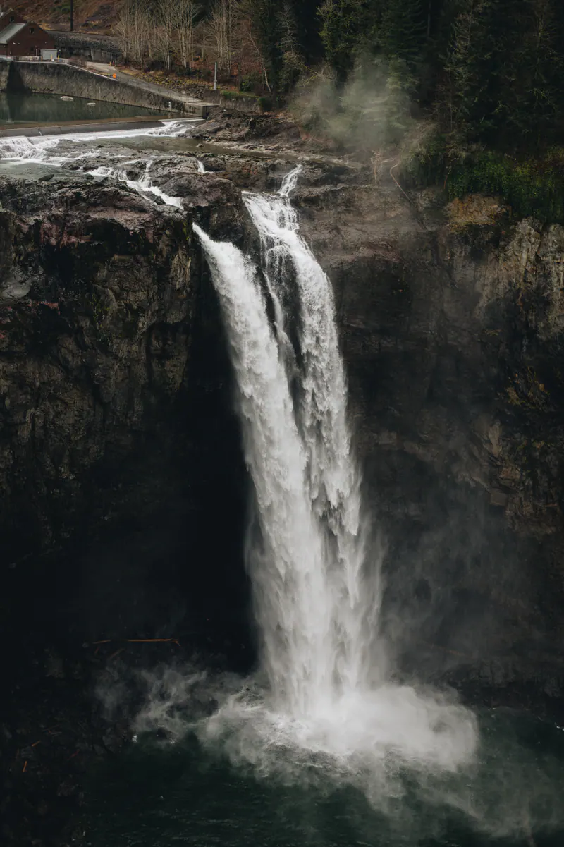 Two streams of a waterfall plunging down a dark rock face